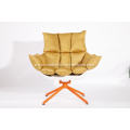 white husk chair with orange seat cushion